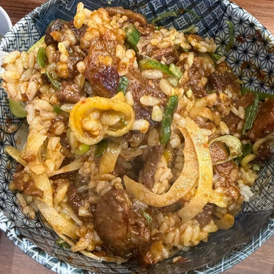 Spicy rib rice bowl mixed with onion and scallion