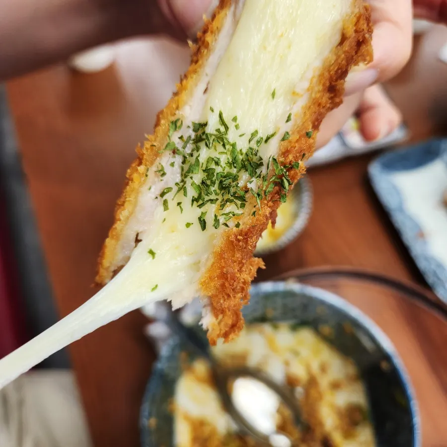 Cheese stretching from the mozzarella cheese katsu