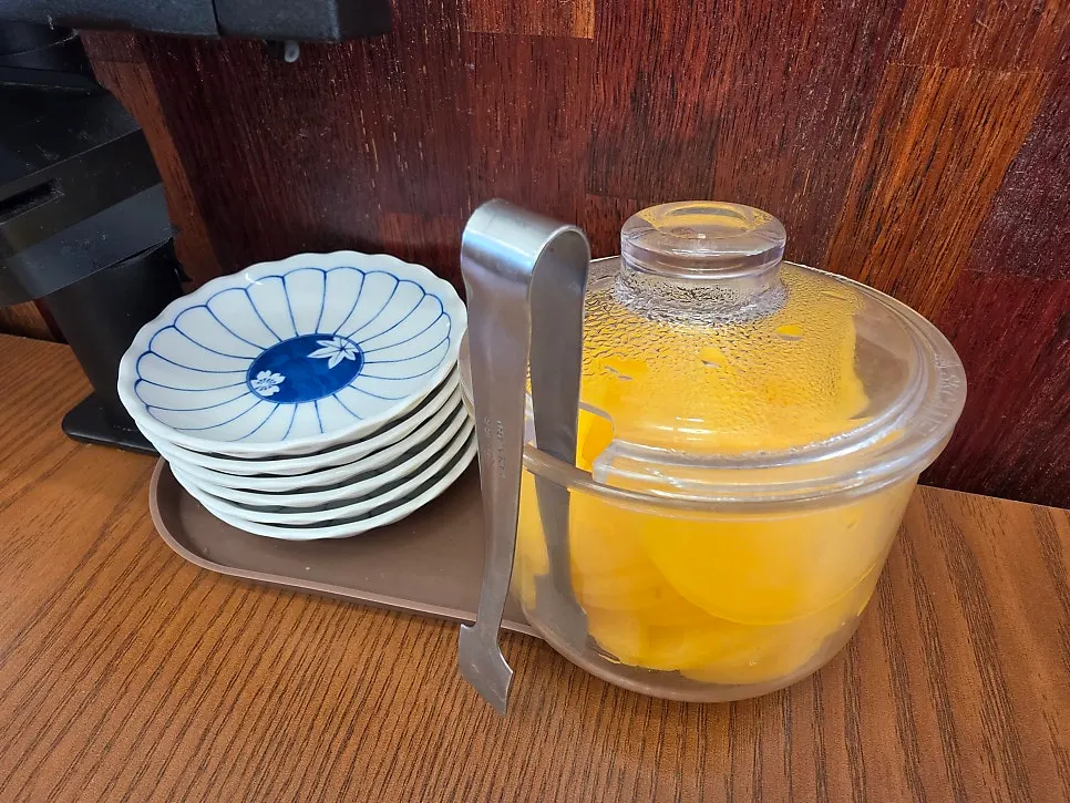 Table setting with small plates, sauce dishes, and pickled radish