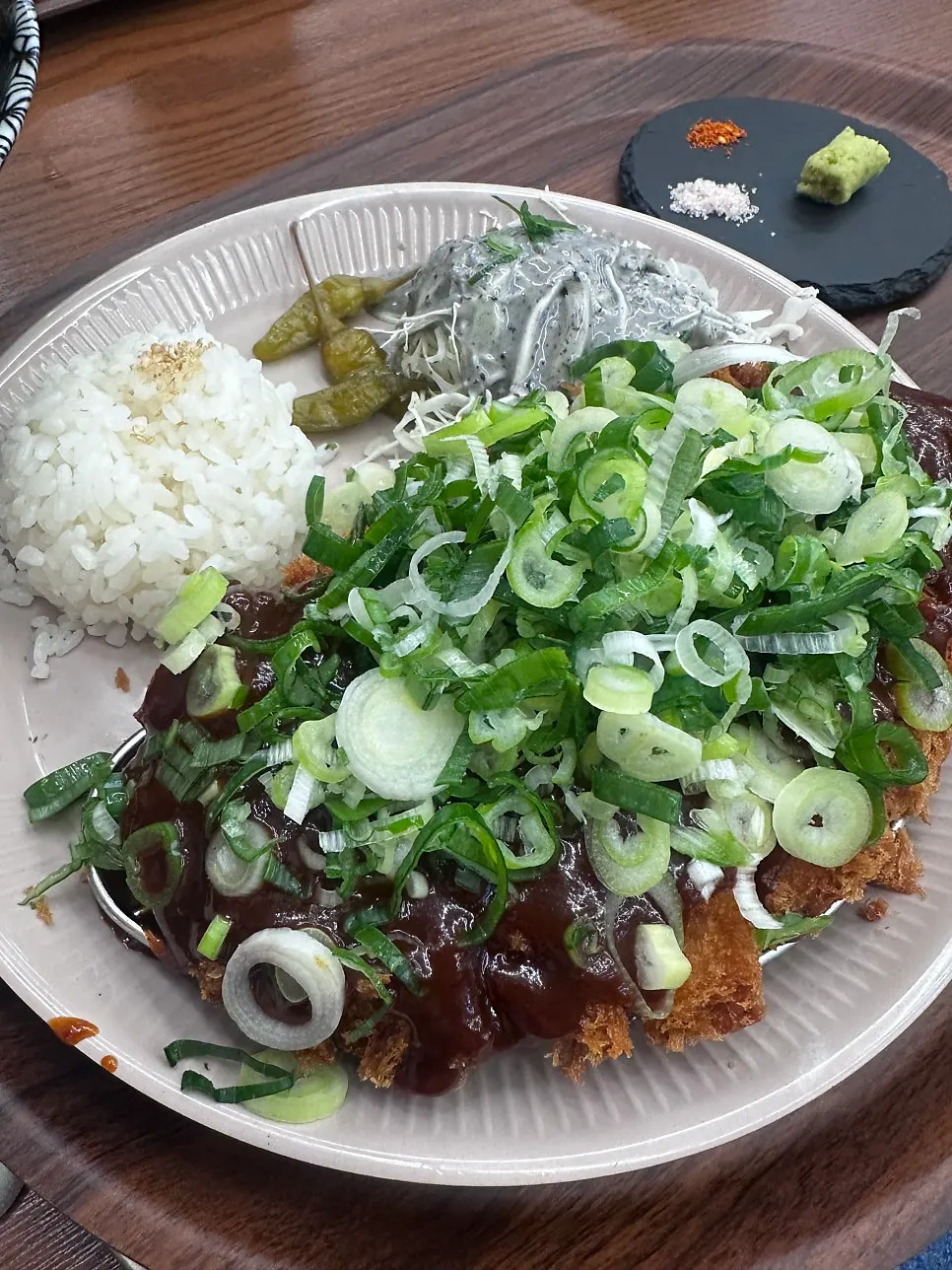 Cross-section of pork loin katsu topped with spicy sauce