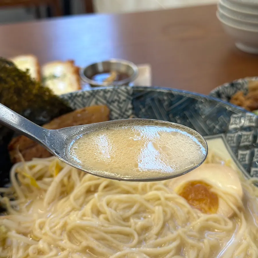 A spoonful of rich pork-bone broth