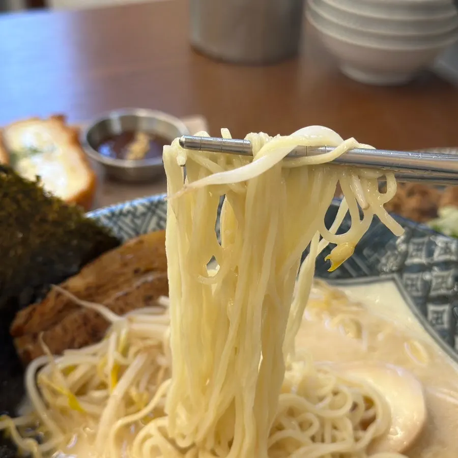 Ramen noodles lifted with chopsticks