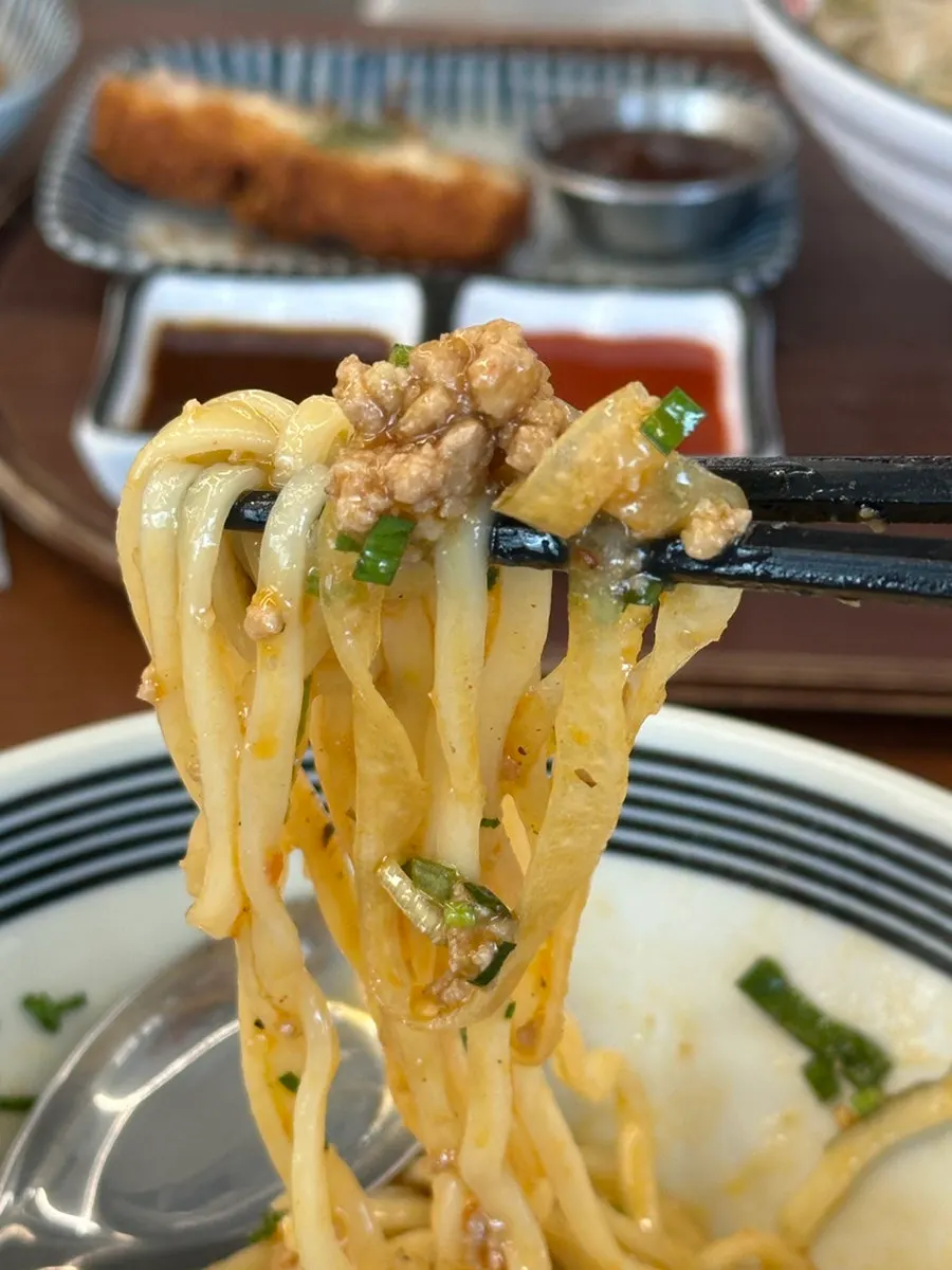 Close-up of mazesoba topped with egg yolk