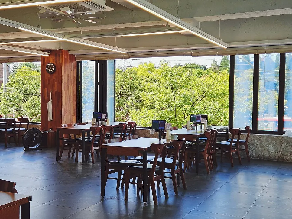 Dining hall with a big window showing Keimyung University's front gate