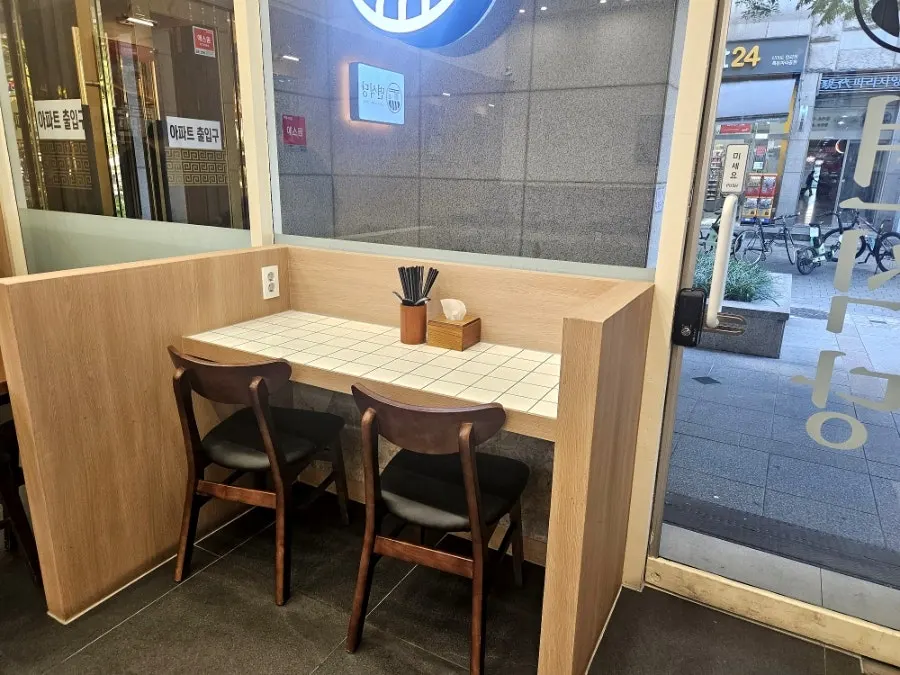 View of the restaurant seating area with window seats visible