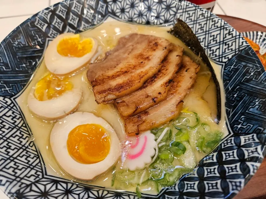 Close-up of tonkotsu ramen topped with seaweed and green onion
