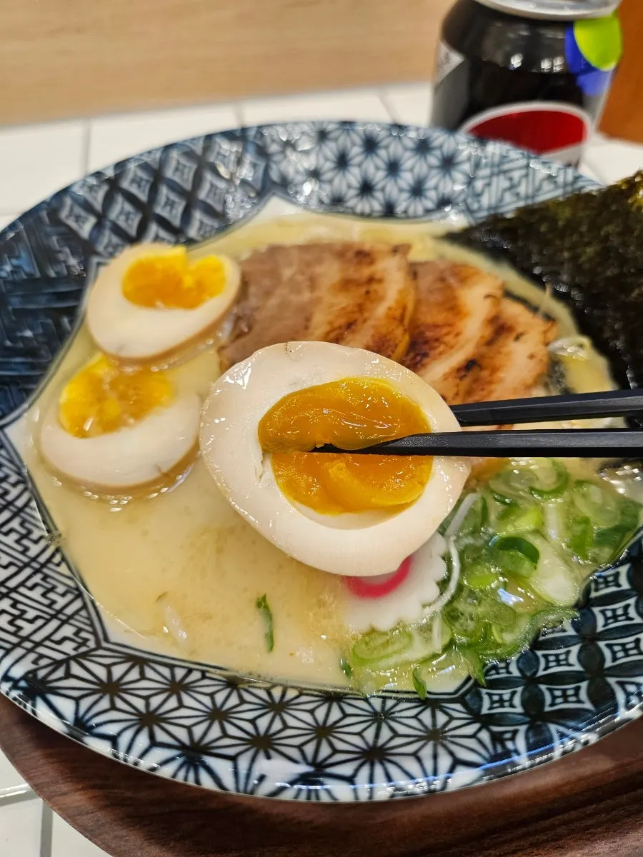 Picking up a thick slice of chashu