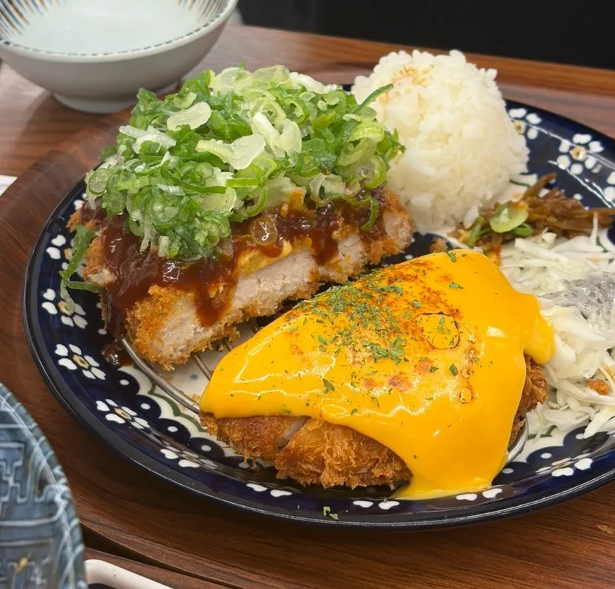 A plate with half cheddar cheese tonkatsu and half spicy tonkatsu