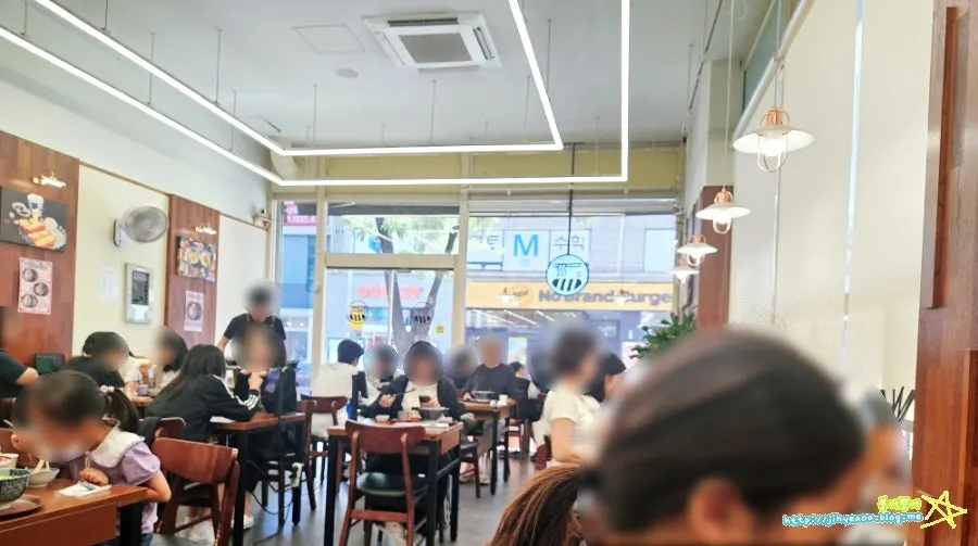 Restaurant interior filled with lunchtime customers