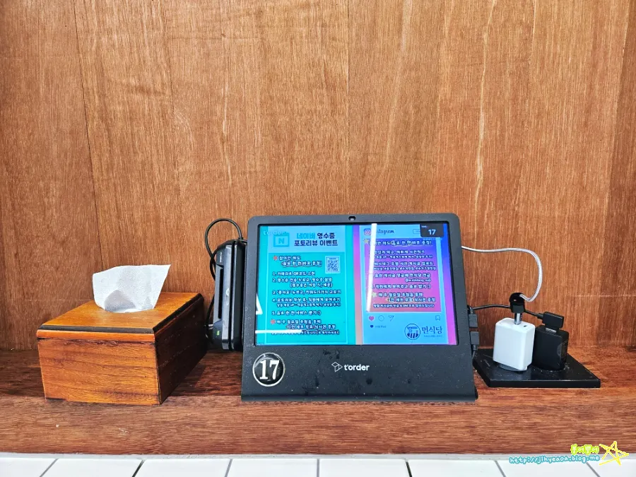 Tablet ordering device and phone charger on the table