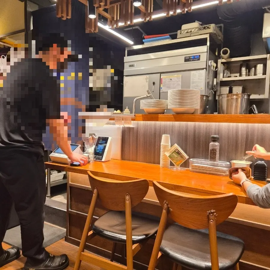 Self-order kiosk at the entrance and interior of the restaurant