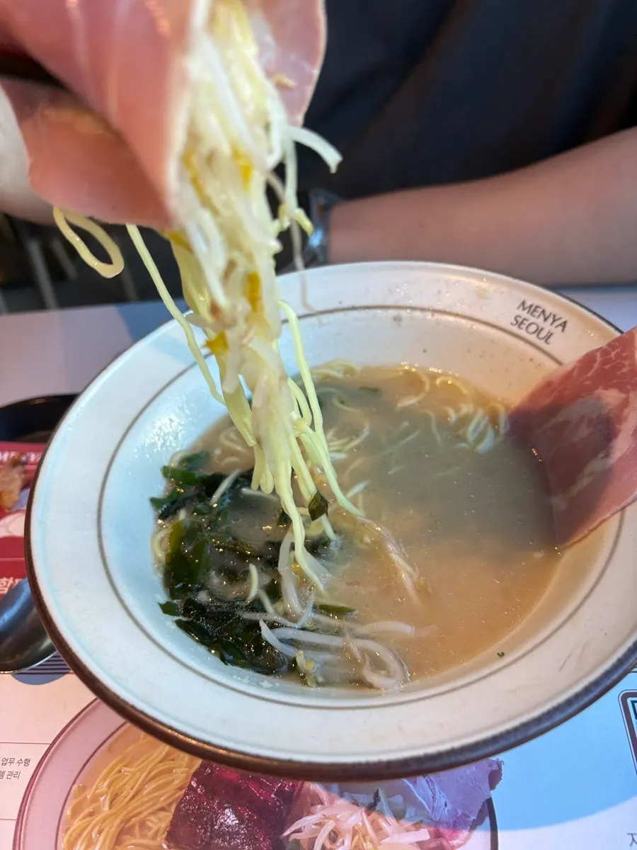 Noodles lifted up from the dongpo pork chashu ramen