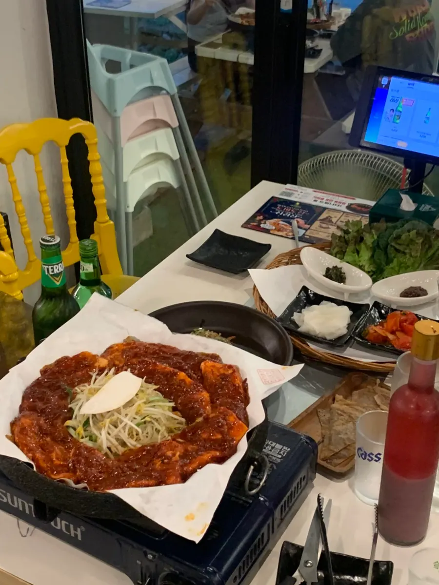 Side dish spread with japchae, wheat crepes, tomato kimchi and more