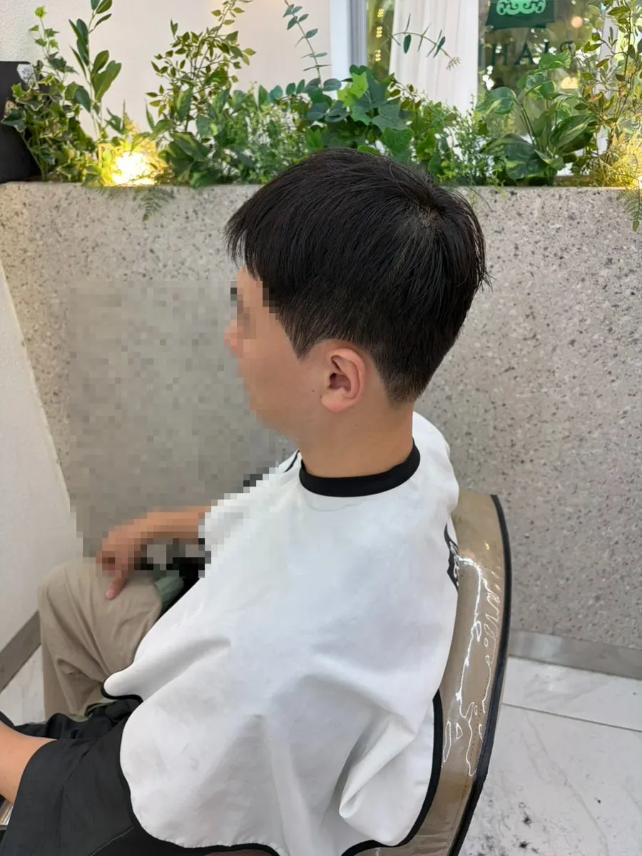 Checking the direction of hair flare in front of the mirror