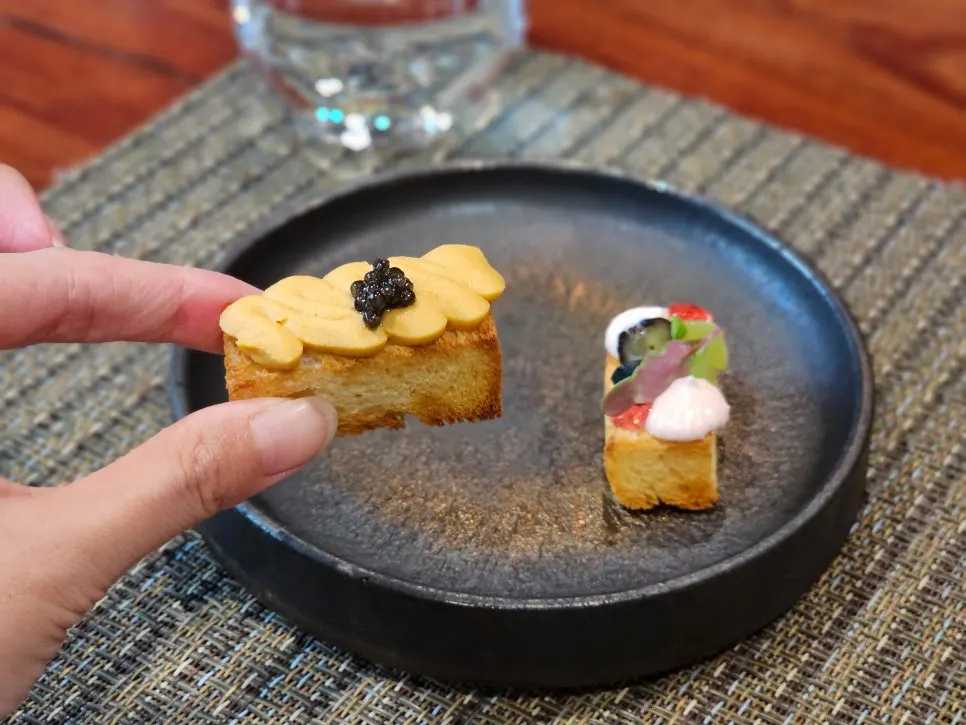 Two amuse-bouche bites topped with uni mousse and caviar