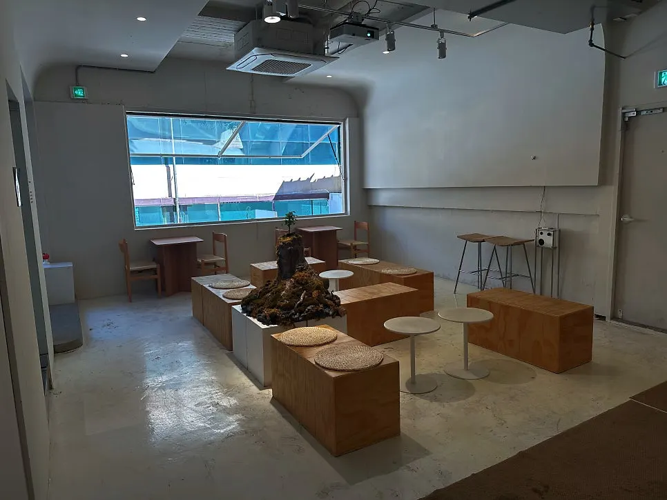 Wooden table and projector video in the first-floor Bare space