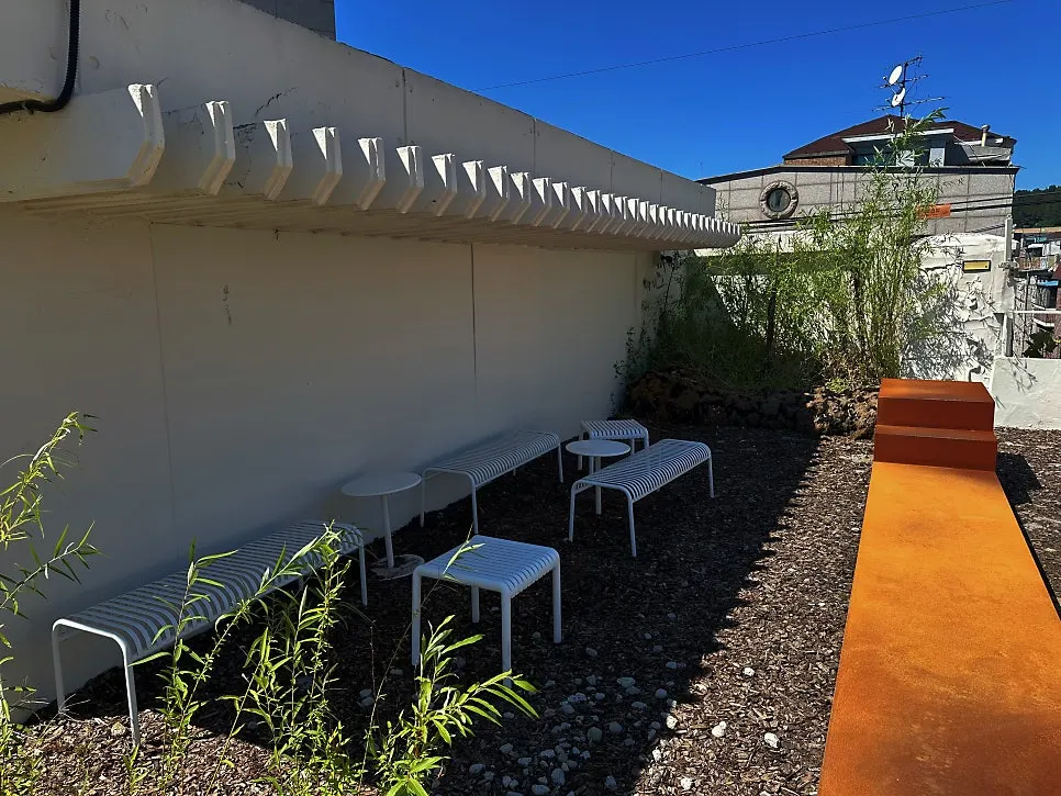 White benches and stools in the rooftop garden