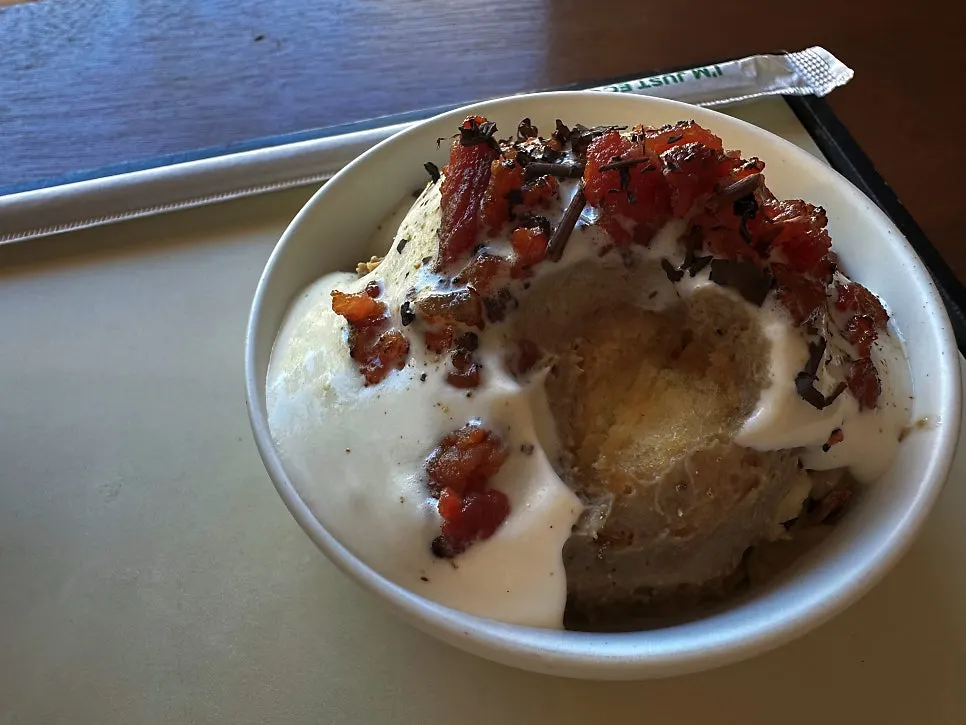 Close-up of hojicha pudding topped with bacon