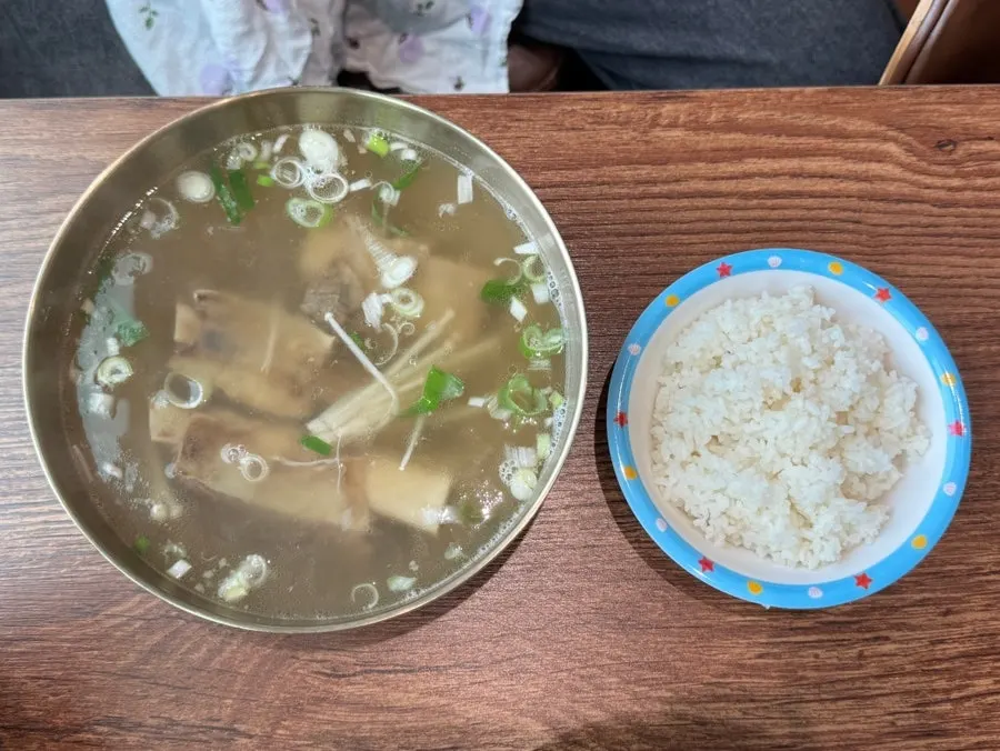 Warm soup dish served alongside the bibim naengmyeon