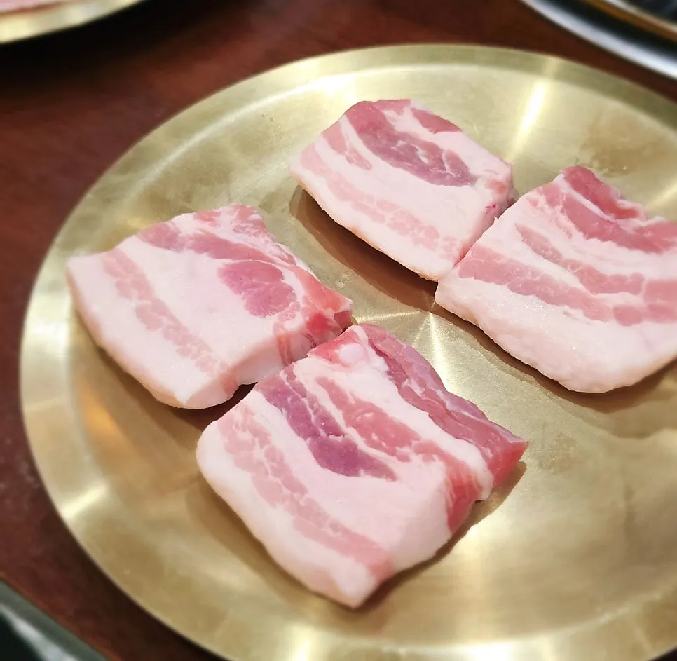 A plate of thick pork belly ordered in a 100g portion