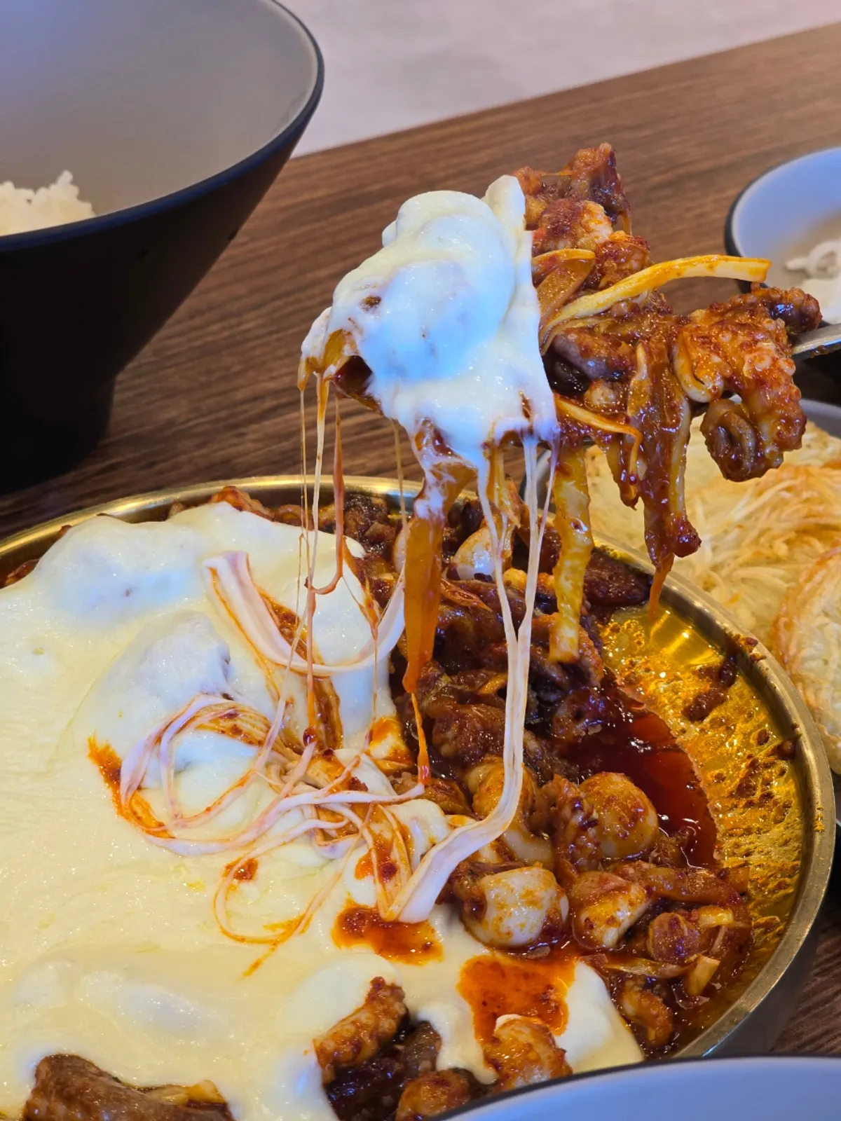 Hot plate of cheese bomb spicy octopus piled with cheese