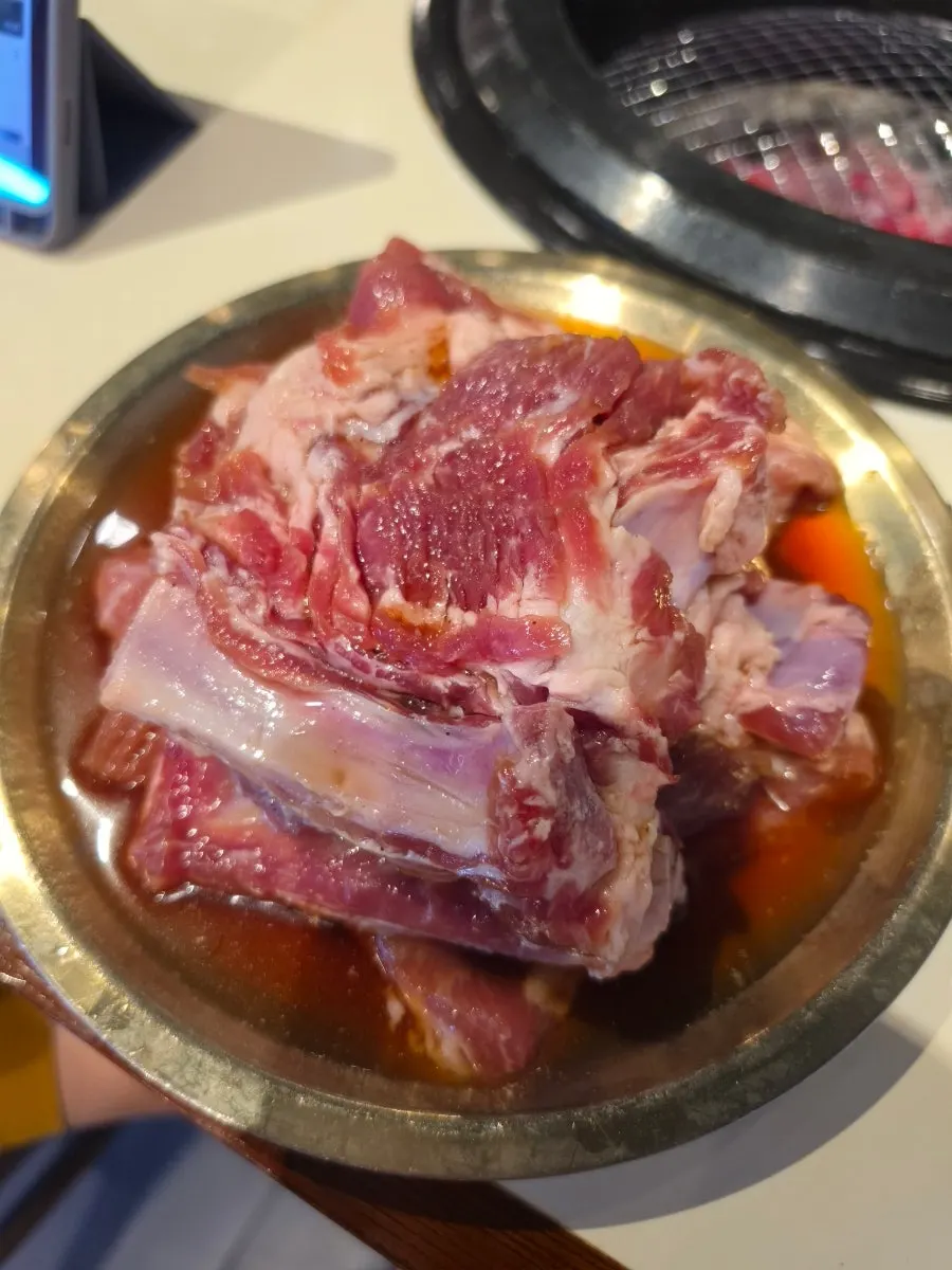 Marinated pork ribs cooking on a charcoal grill