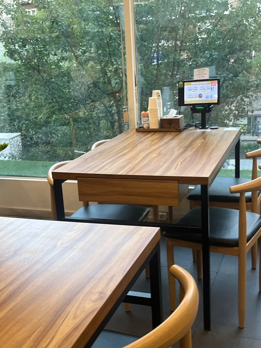 Seating area with wooden tables at Nagwon-ui Soba