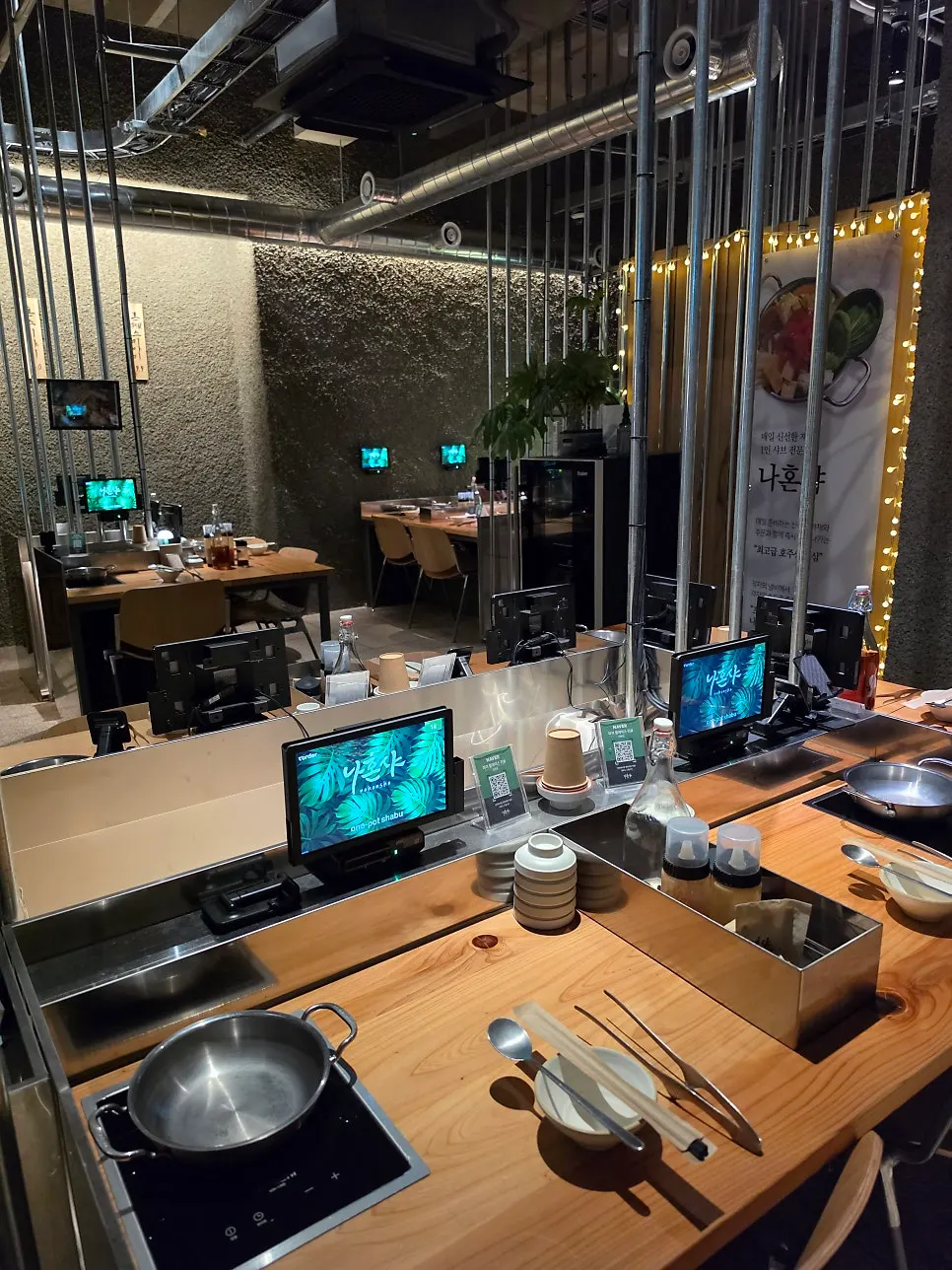Interior seating at Nahonsha with an induction burner and personal monitor
