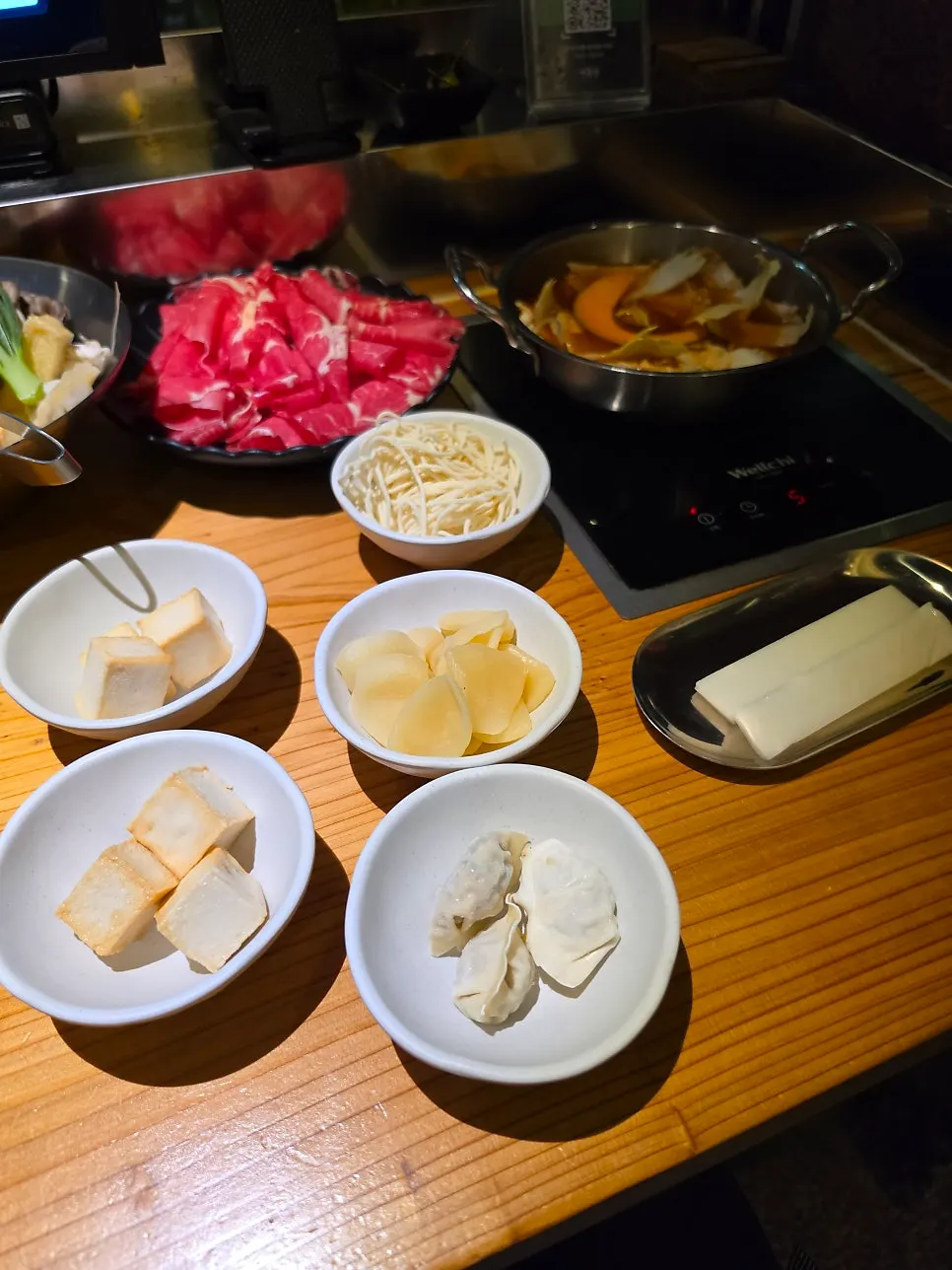 Plate of extra ingredients: fried tofu, potato, and dumplings