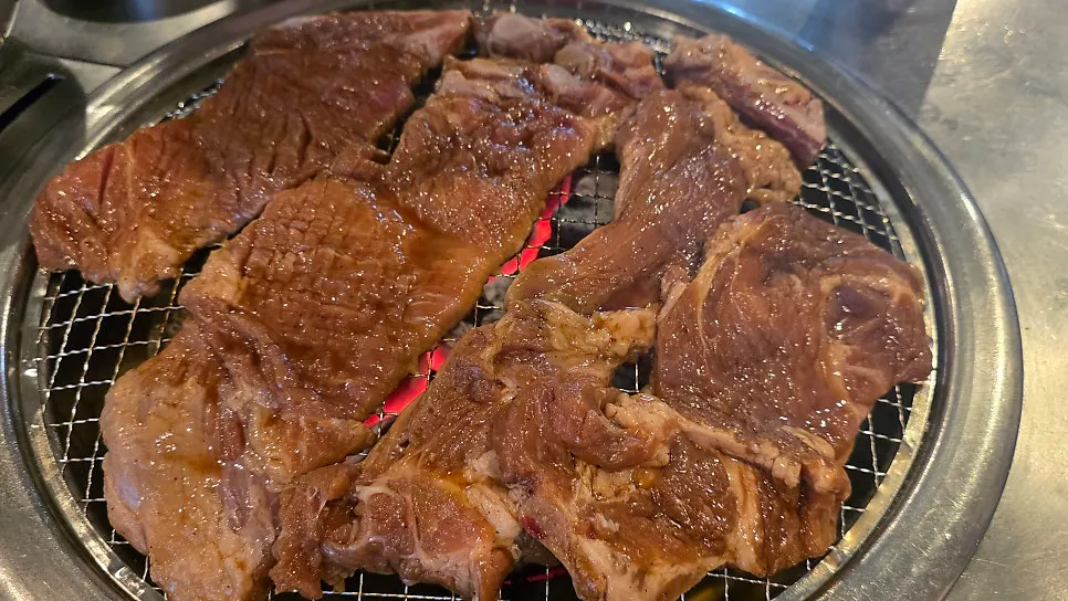 鉄板いっぱいの味付け豚カルビの炭火焼き