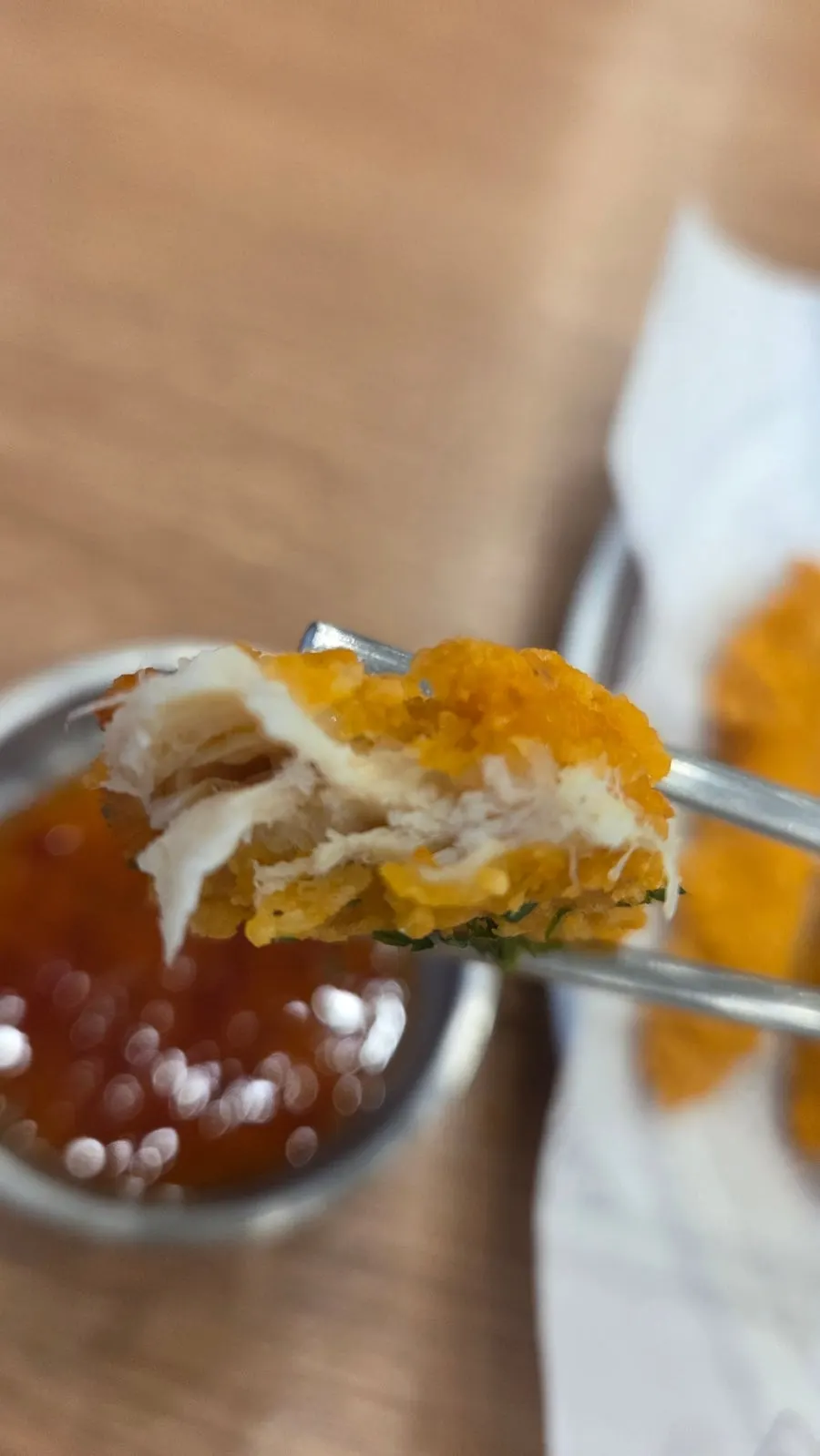 Chicken tenders served alongside pork cutlet