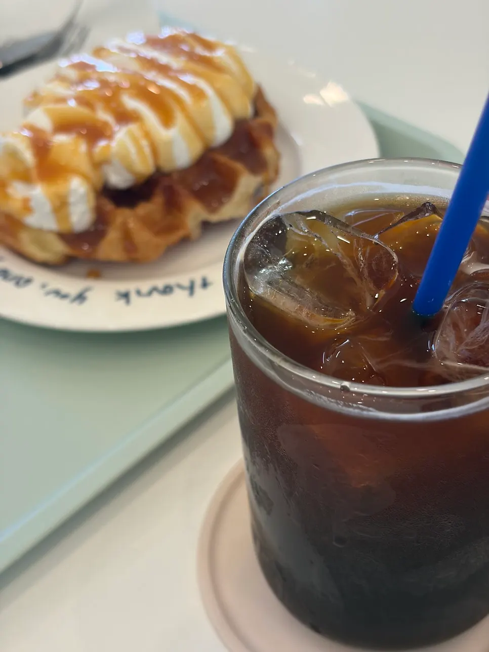 Iced americano next to the salt caramel croffle