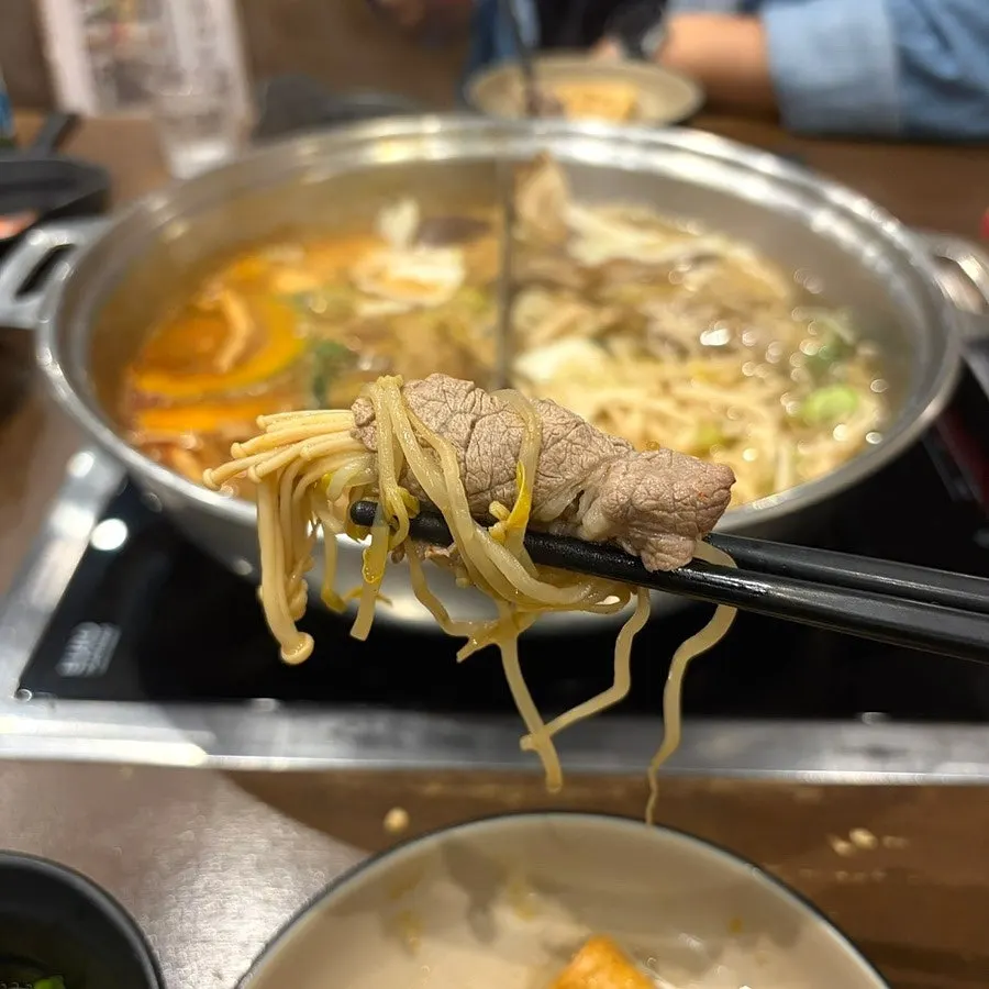 Noodles lifted out of the boiling broth