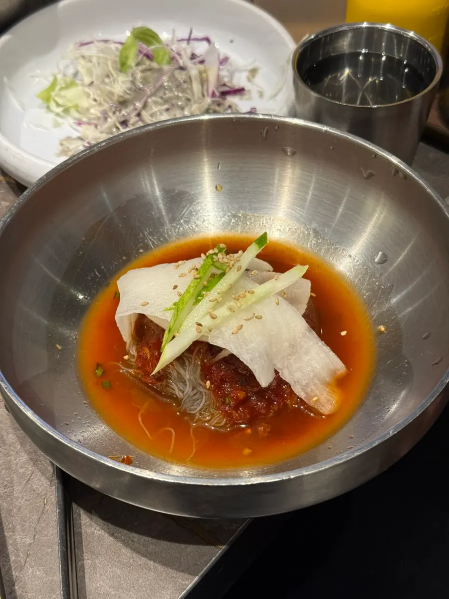 Bibim naengmyeon enjoyed alongside the meat