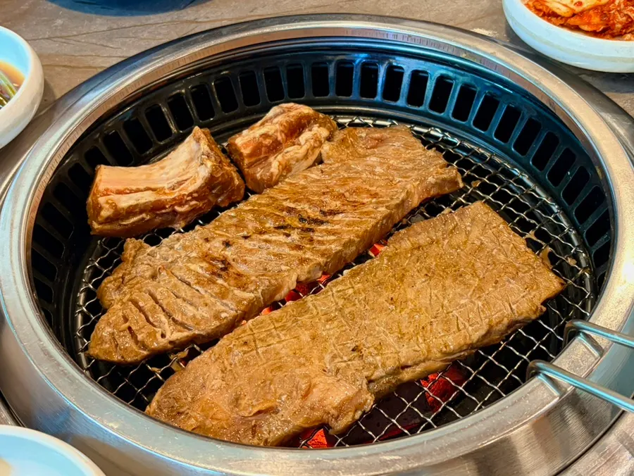 Hwangchil king galbi cooking over charcoal