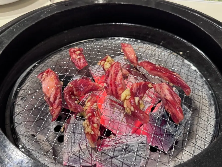Beef short rib meat cooking over charcoal