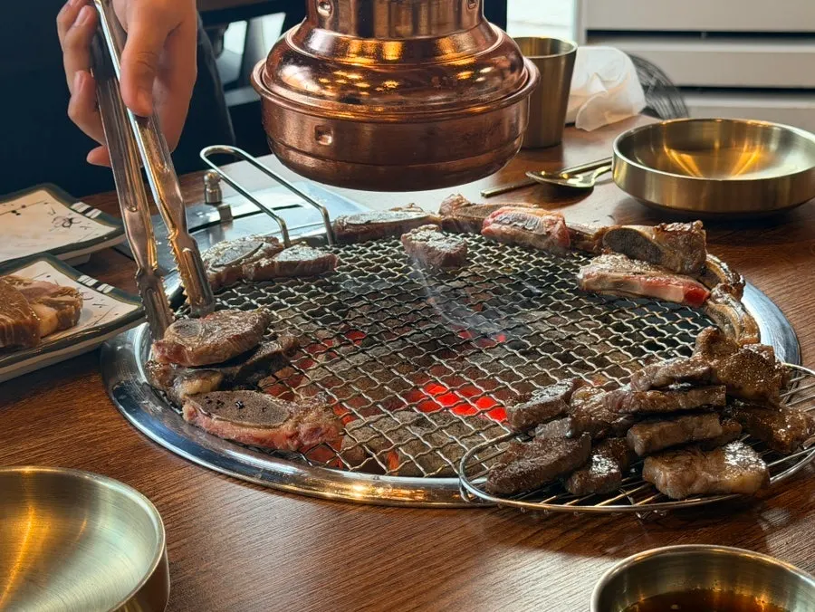 Staff grilling ribs on the grill plate