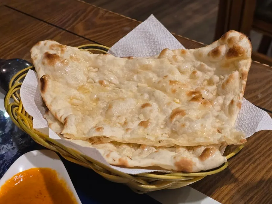 Garlic naan baked in a tandoor oven with plain rice