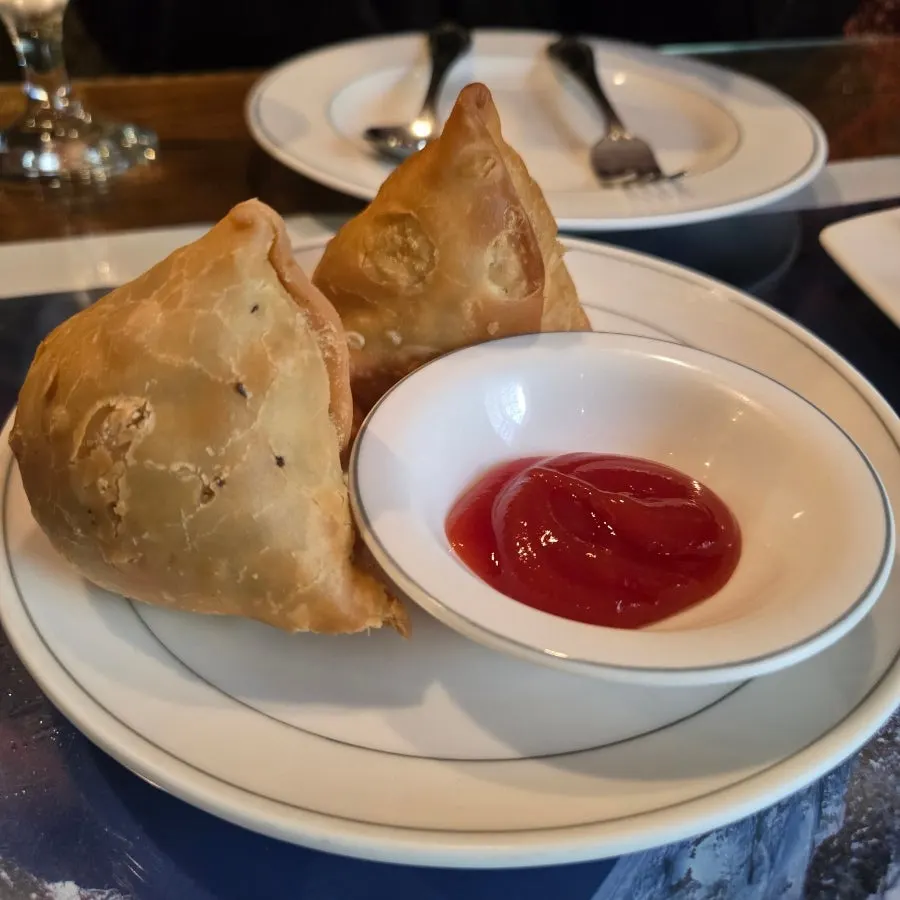 Plate with 2 hefty samosas