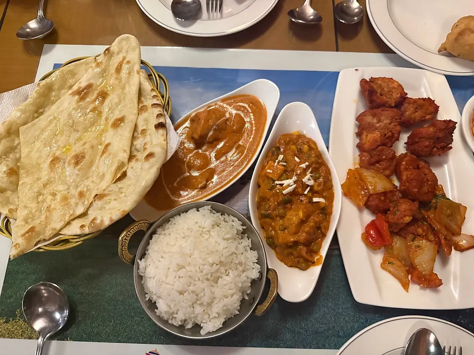 Two bowls of vegetable curry and chicken curry