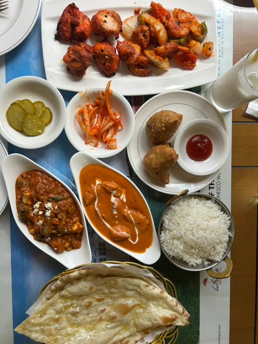 Bàn ăn với đồ trang trí phong cách Ấn Độ và ly nước
