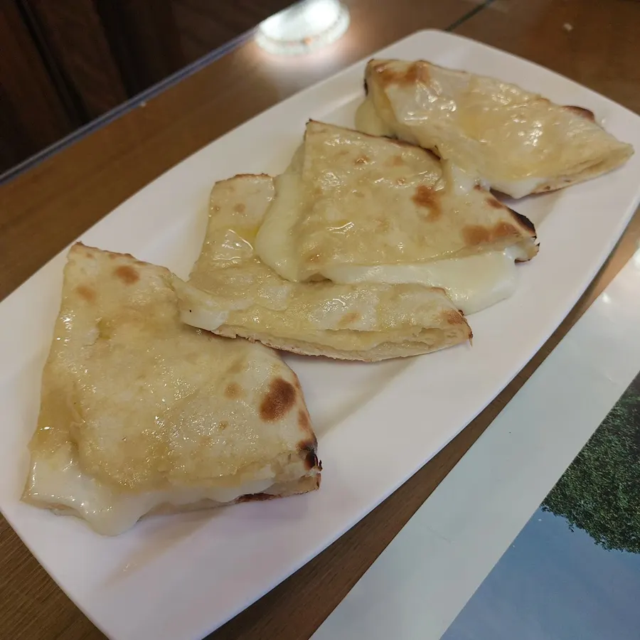 Cheese naan at Namaste Dongmyo Branch stretching with melted cheese