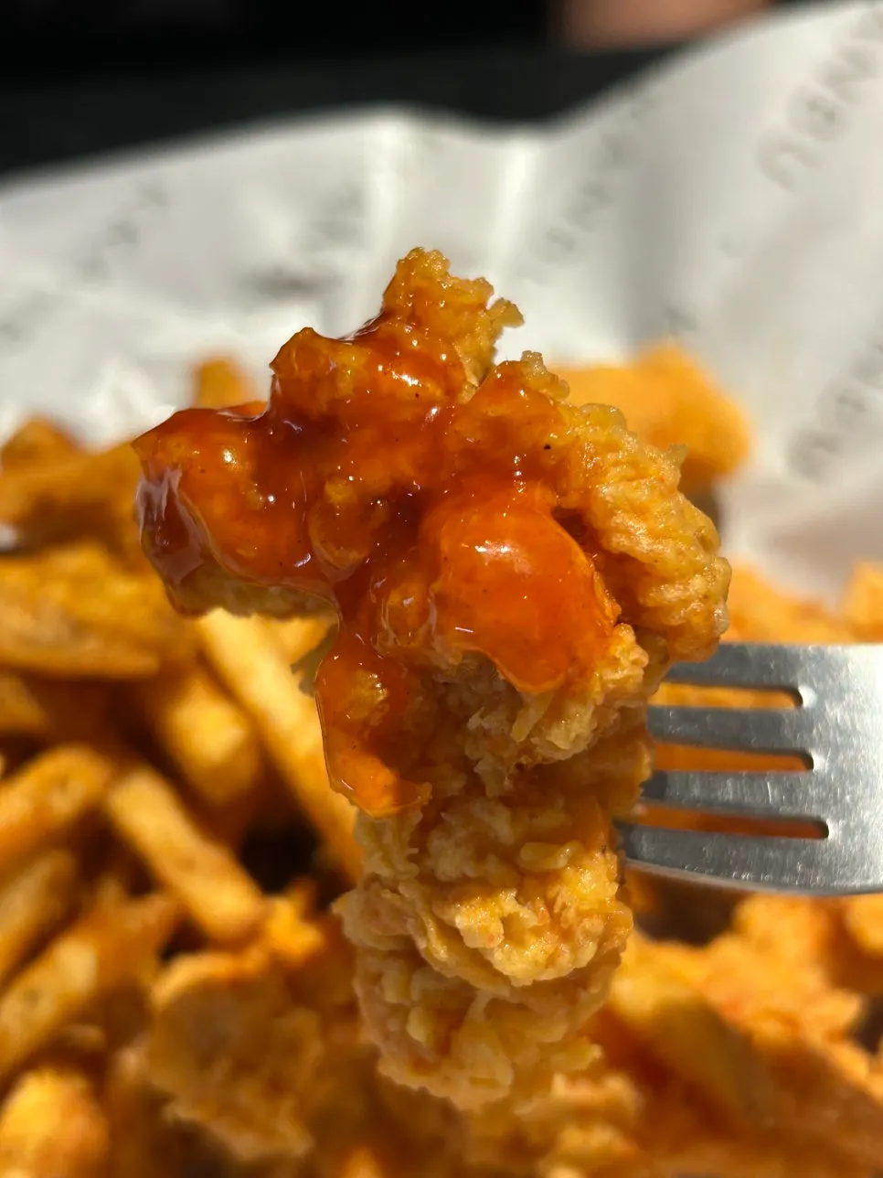 Crispy boneless chicken dipped in sauce
