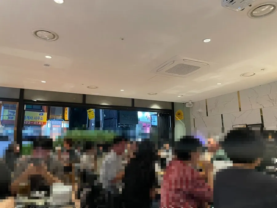 Indoor table at Kkanbu Chicken with the window open