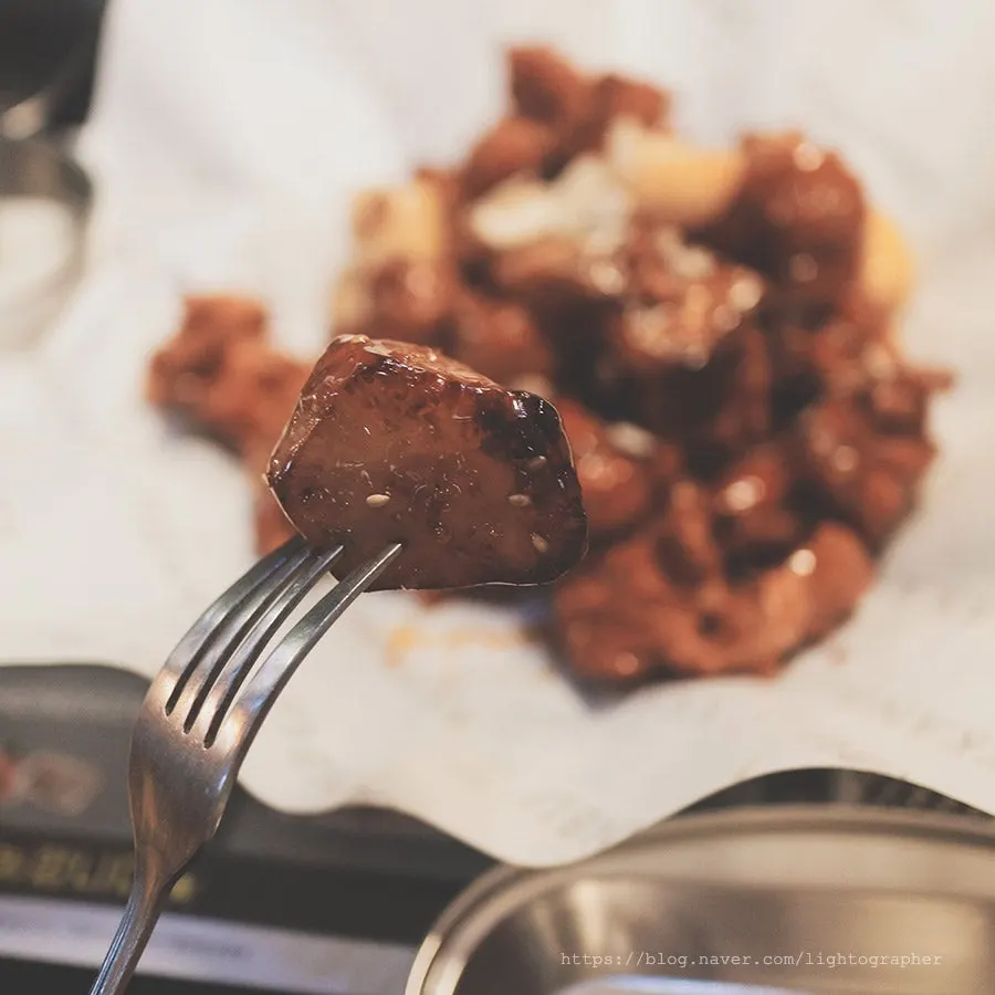 Cross-section of sauce-coated boneless chicken showing juicy meat