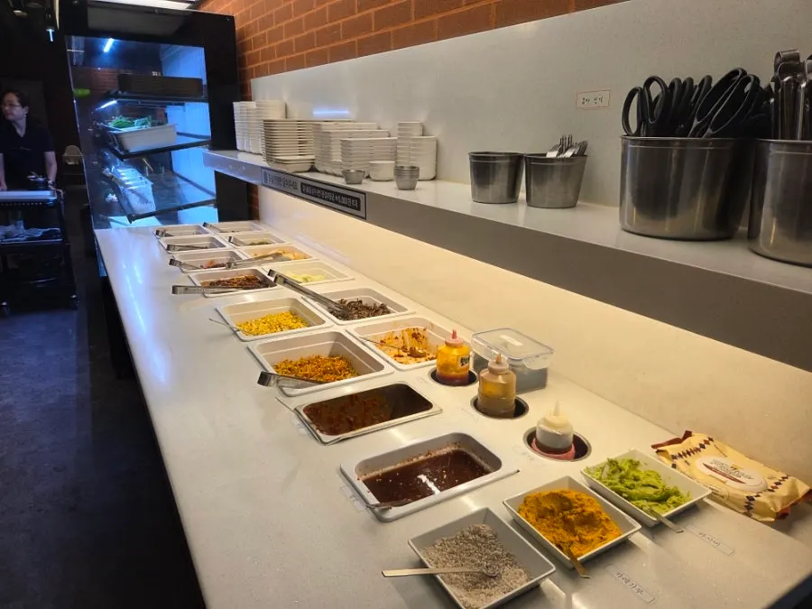 Self-service bar with wrap greens and side dishes