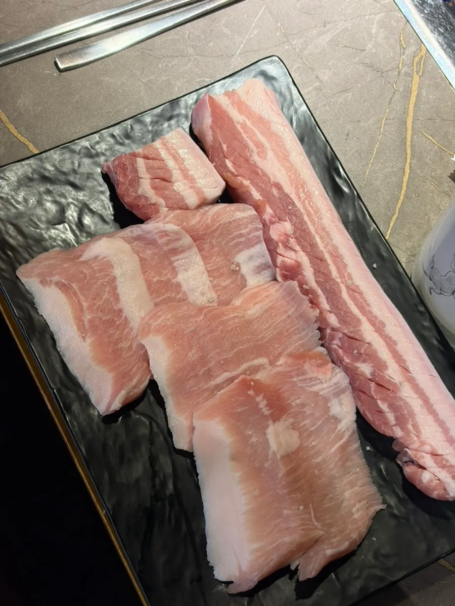 Thick aged pork belly on the grill