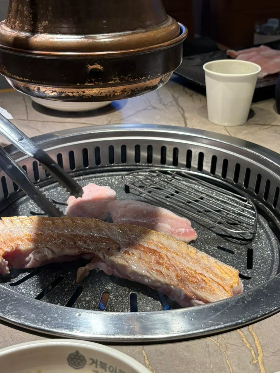 Grilled meat flipped, showing browned color