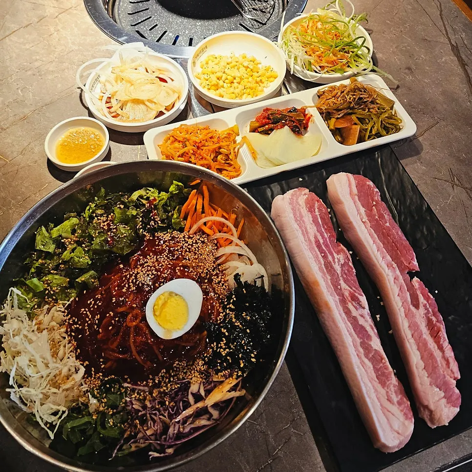 Full table setting of the jjolmyeon pork belly set