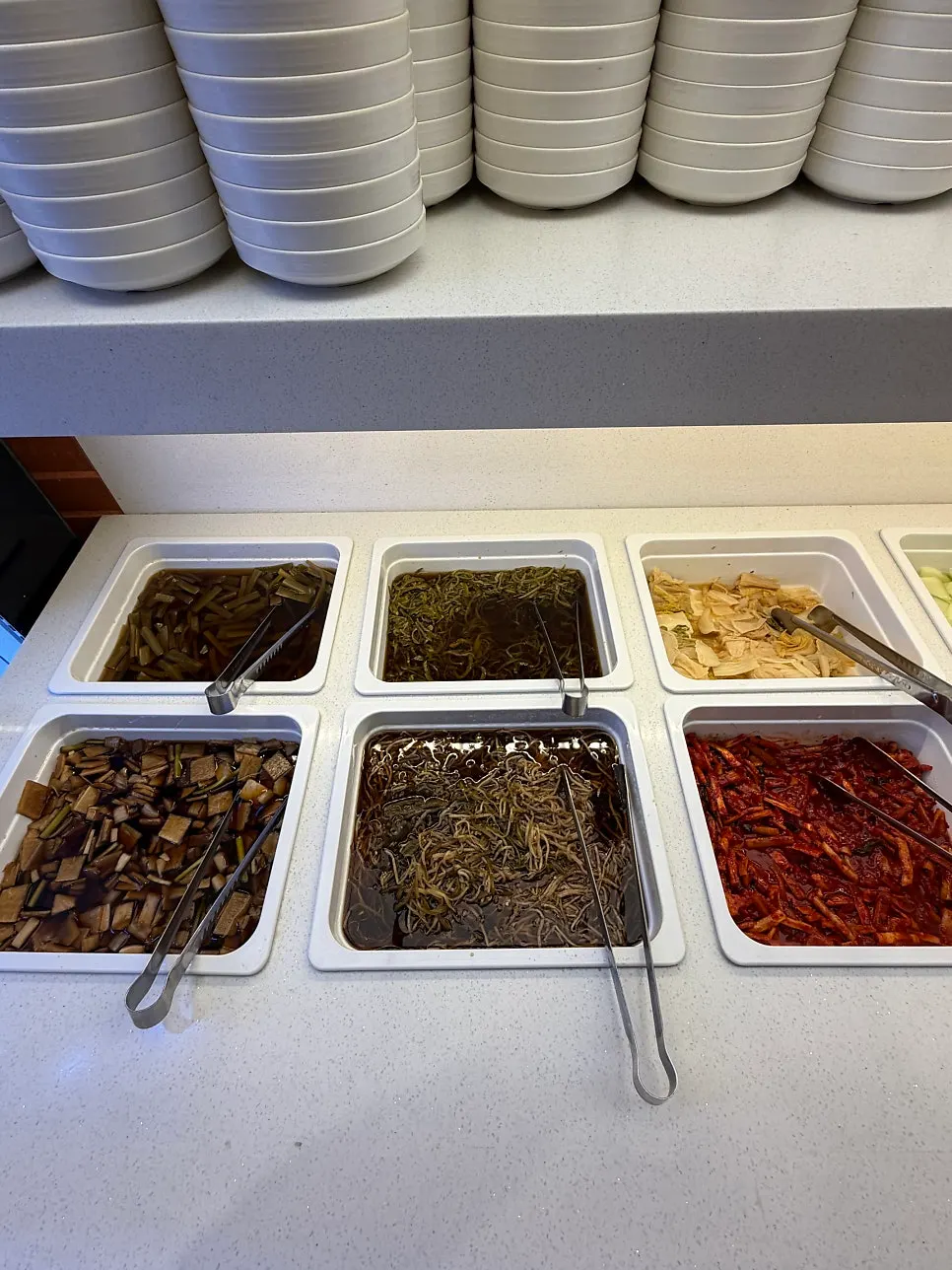 Self-serve bar with various banchan and sauces
